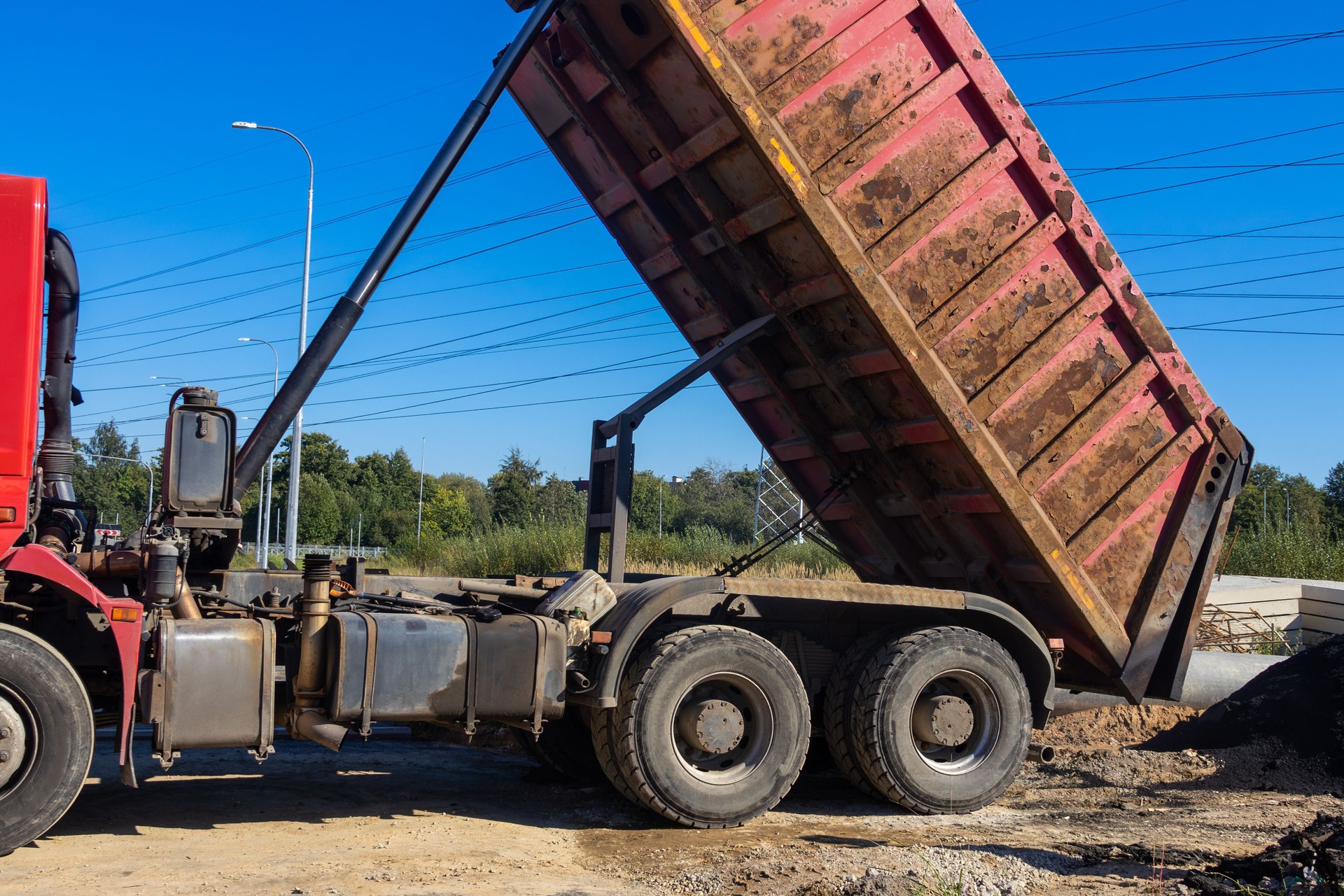 Dump truck is dumping its load of dirt