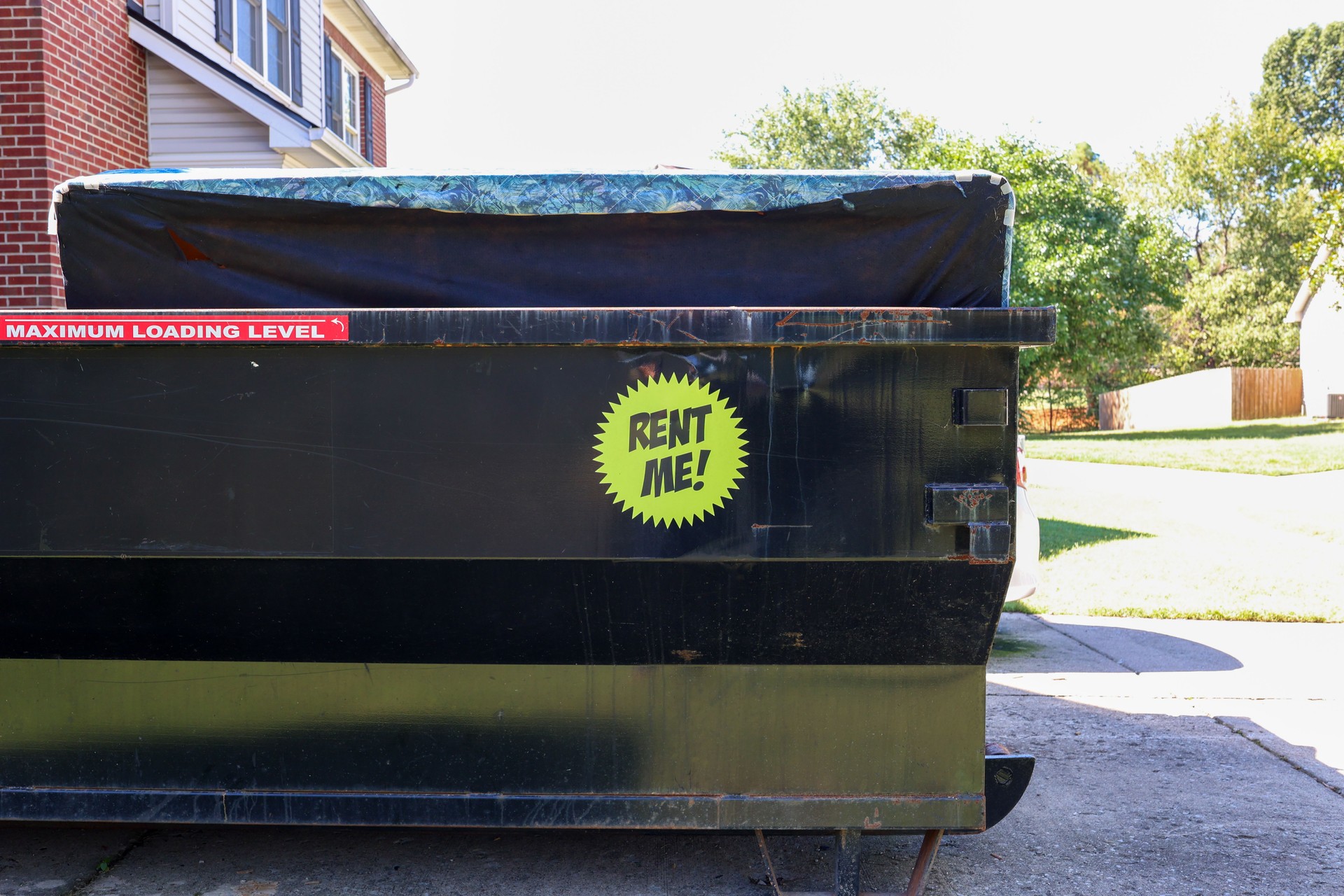 A rented dumpster in a  residential driveway